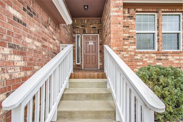 property entrance featuring brick siding