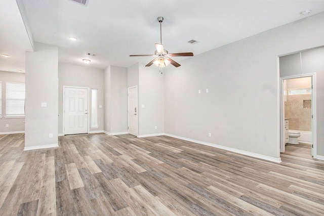 unfurnished living room with ceiling fan, light wood-type flooring, visible vents, and baseboards