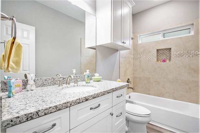 bathroom with  shower combination, wood finished floors, vanity, and toilet