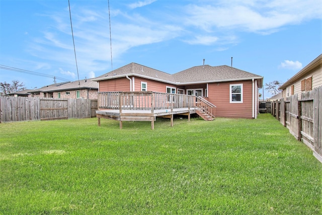 back of property featuring a shingled roof, a fenced backyard, a yard, and a deck