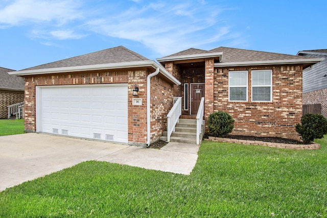 view of front facade with an attached garage, a shingled roof, a front yard, and brick siding