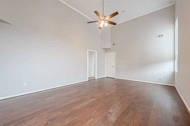 unfurnished room with dark wood-style flooring, crown molding, visible vents, ceiling fan, and baseboards