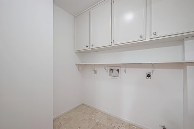 laundry area featuring washer hookup, cabinet space, electric dryer hookup, and baseboards