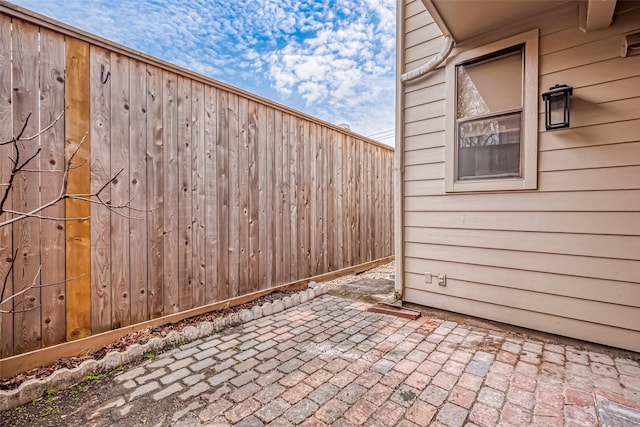 view of patio featuring fence