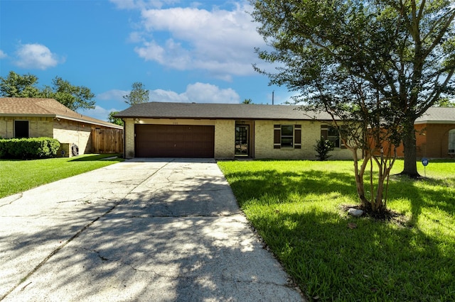 single story home featuring a garage, driveway, a front lawn, and brick siding