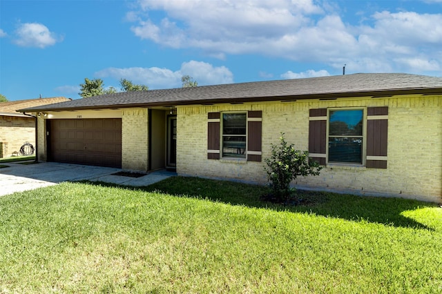 ranch-style house with a garage, concrete driveway, a front lawn, and roof with shingles