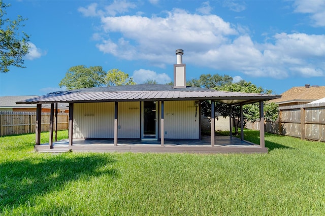 back of house with a fenced backyard, a yard, and a patio