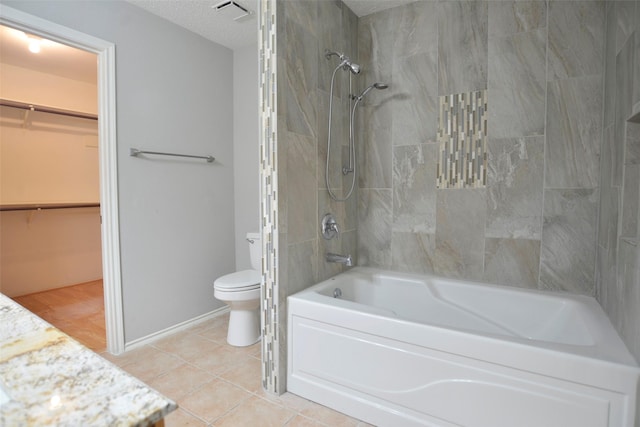 bathroom featuring tile patterned floors, toilet, a walk in closet, visible vents, and  shower combination