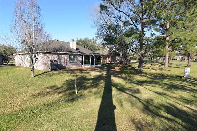 view of yard with a sunroom