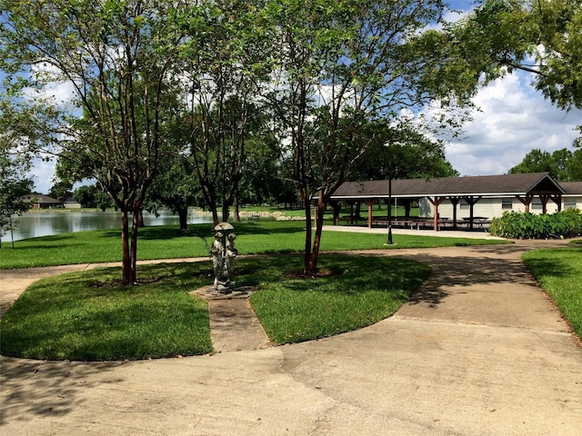 view of home's community with a lawn, a gazebo, and a water view