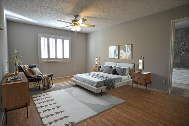 bedroom with baseboards, wood finished floors, a ceiling fan, and a textured ceiling