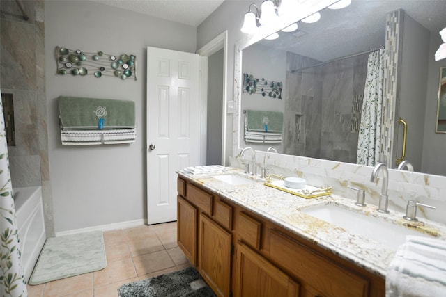 bathroom with tile patterned floors, baseboards, double vanity, and a sink