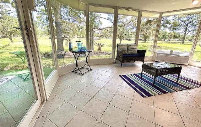 sunroom featuring a wall mounted AC