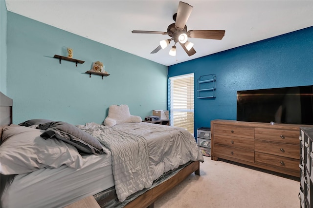 bedroom featuring a ceiling fan and carpet