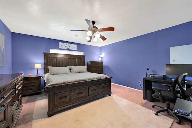 carpeted bedroom with a ceiling fan and baseboards