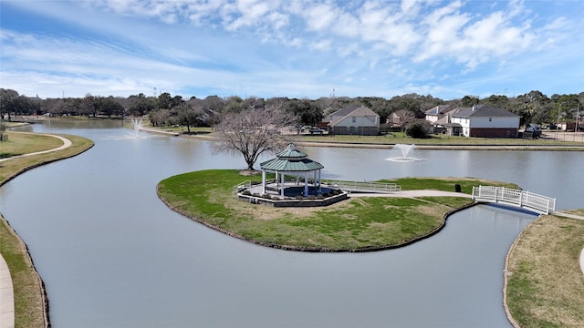 view of property's community with a gazebo and a water view