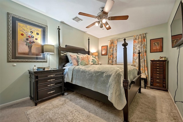 bedroom featuring light carpet, baseboards, visible vents, and a ceiling fan