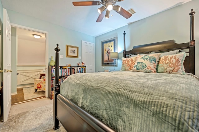 bedroom with ceiling fan, visible vents, and light colored carpet