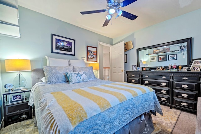 bedroom with ceiling fan and light colored carpet