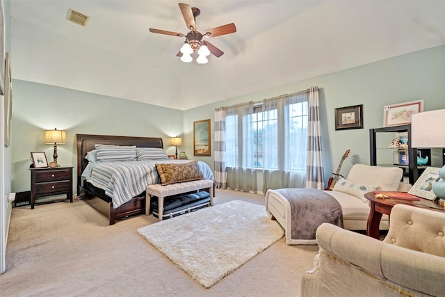 bedroom with visible vents, ceiling fan, and light carpet