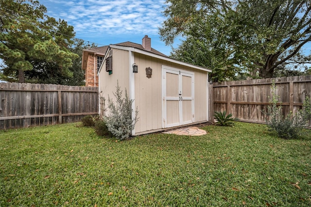 view of shed with a fenced backyard