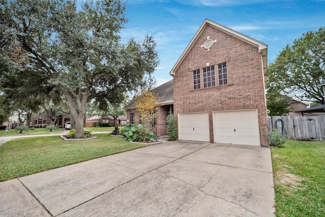 traditional-style house with a garage, brick siding, fence, and a front lawn