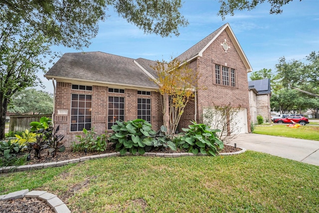 traditional home with an attached garage, brick siding, a shingled roof, driveway, and a front yard