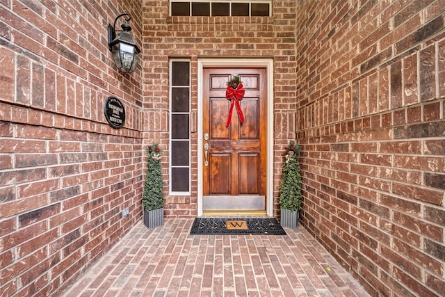 property entrance with brick siding