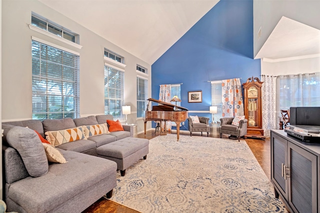 living room with high vaulted ceiling and baseboards