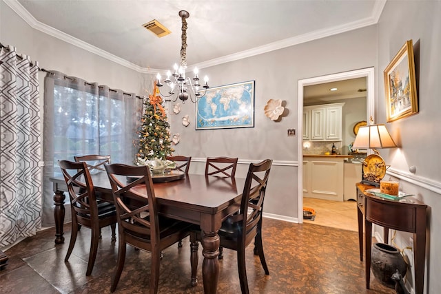 dining room featuring visible vents, a notable chandelier, and ornamental molding