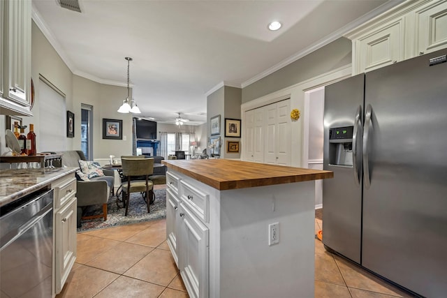 kitchen featuring light tile patterned floors, stainless steel appliances, butcher block countertops, a kitchen island, and open floor plan