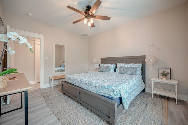 bedroom featuring baseboards, visible vents, and light wood-style floors