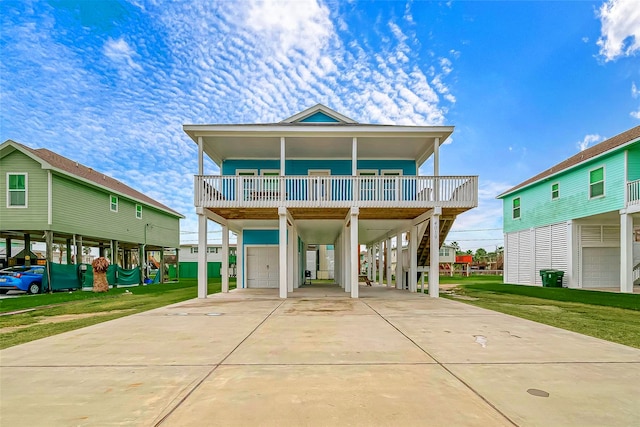 4019 Mason Dr, Galveston, TX 77554 - coastal home featuring concrete driveway, stairs, a porch, a carport, and a front yard