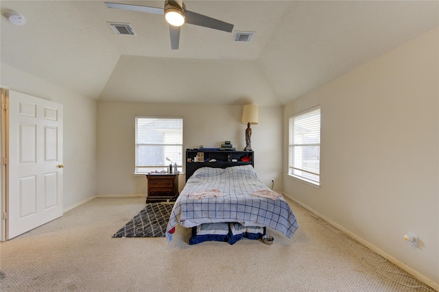 bedroom with vaulted ceiling, light carpet, visible vents, and baseboards