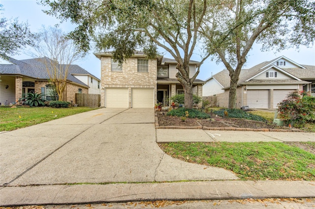 traditional home with concrete driveway, brick siding, an attached garage, and fence