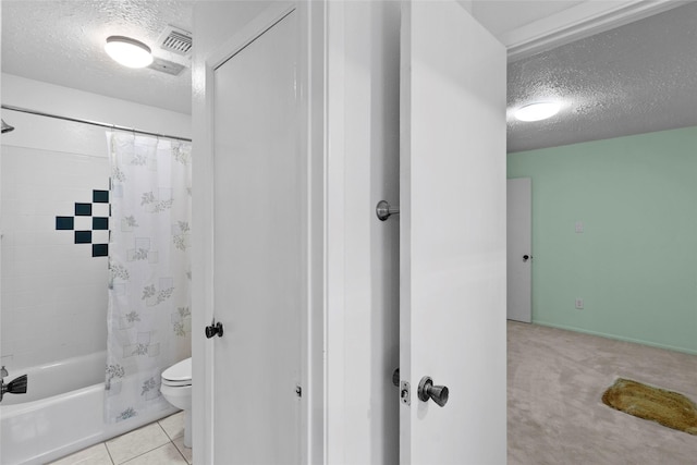 full bath with shower / tub combo, visible vents, toilet, tile patterned flooring, and a textured ceiling