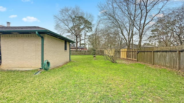 view of yard with a fenced backyard