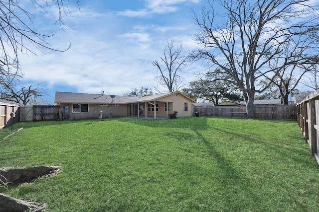 view of yard with a fenced backyard