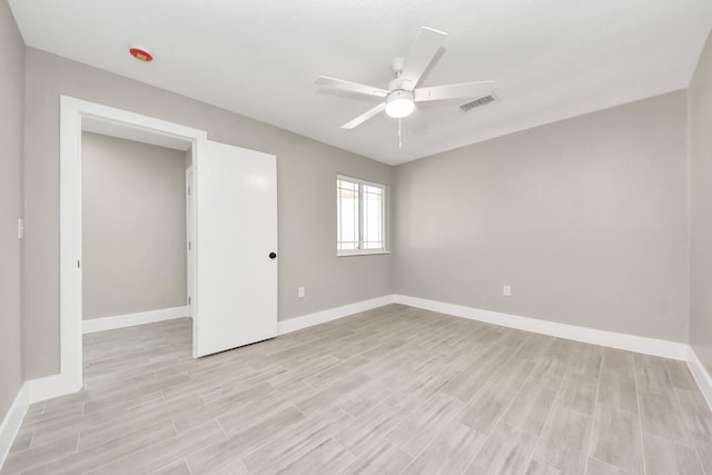 unfurnished bedroom featuring light wood-style flooring, visible vents, and baseboards