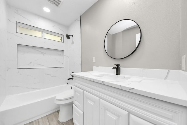 full bathroom with visible vents, toilet, wood finished floors, bathtub / shower combination, and vanity