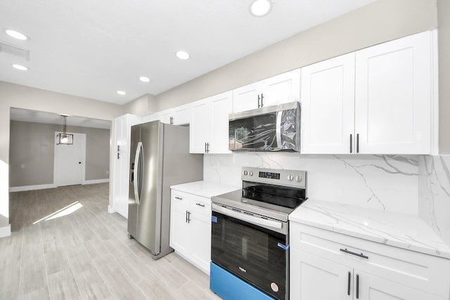 kitchen with decorative light fixtures, stainless steel appliances, visible vents, decorative backsplash, and white cabinetry