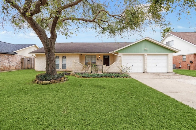 ranch-style home featuring a garage, concrete driveway, fence, a front lawn, and brick siding