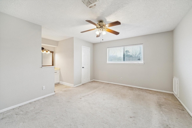 unfurnished bedroom with baseboards, visible vents, and light colored carpet