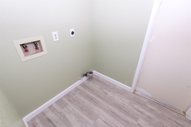 laundry area with laundry area, baseboards, hookup for a washing machine, light wood-style floors, and electric dryer hookup