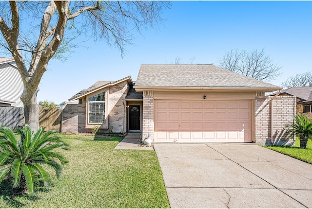 mid-century modern home featuring an attached garage, brick siding, fence, driveway, and a front yard