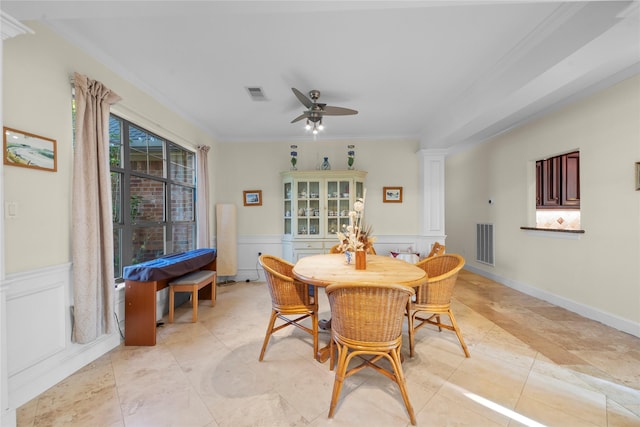 dining area featuring ceiling fan, visible vents, ornamental molding, and wainscoting