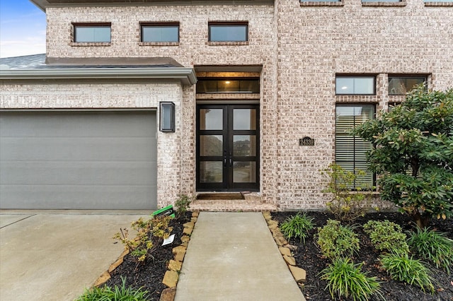 doorway to property featuring french doors and brick siding