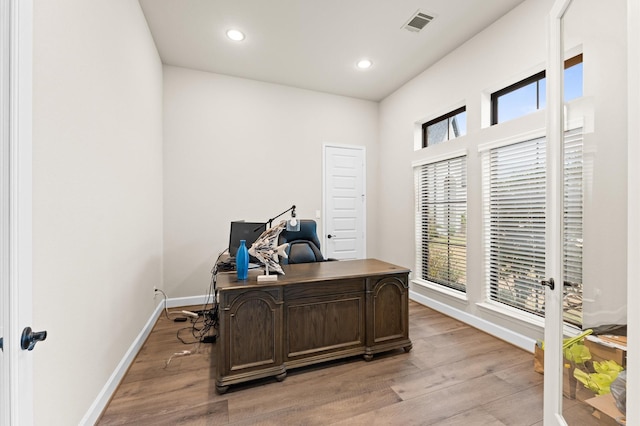 office featuring light wood-style floors, recessed lighting, visible vents, and baseboards