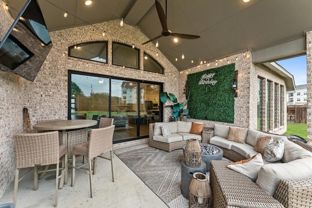 exterior space featuring vaulted ceiling with beams, plenty of natural light, and a ceiling fan