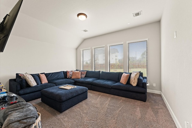 carpeted living area with lofted ceiling, visible vents, and baseboards